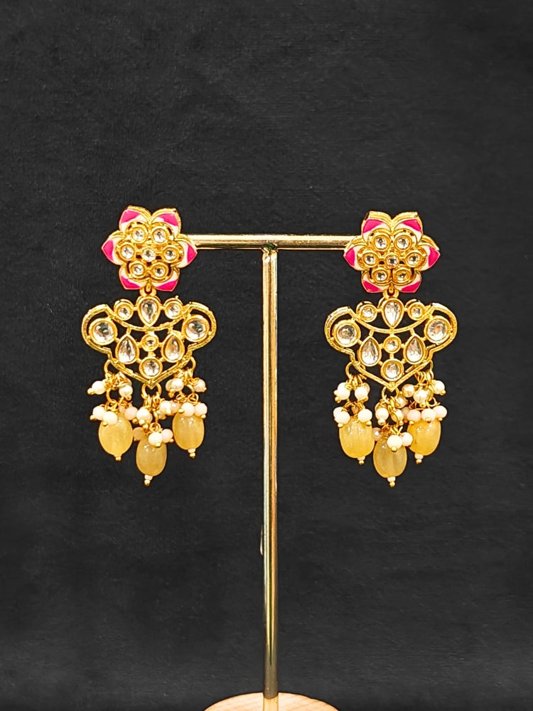 Close-up of an ornate traditional Peach Rajwadi gold Long jewellery set and earrings with Kundan, Meenakari work, crystal beads, pearls, American Diamonds, pearls, Tumble stones and Colored Stones. Close-up of a premium Rajwadi artificial necklace under 10000.
Close-up of a handcrafted Rajwadi artificial jewelry set.