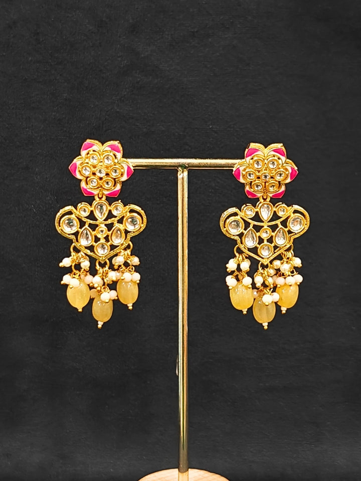 Close-up of an ornate traditional Peach Rajwadi gold Long jewellery set and earrings with Kundan, Meenakari work, crystal beads, pearls, American Diamonds, pearls, Tumble stones and Colored Stones. Close-up of a premium Rajwadi artificial necklace under 10000.
Close-up of a handcrafted Rajwadi artificial jewelry set.