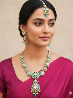 Close-up of a woman wearing an ornate traditional Peach Jewelry Set, Earrings and Mangtikka with Kundan and Colored Stones. Bride wearing a traditional Kundan artificial necklace set for her wedding ceremony. Woman wearing trending Kundan artificial jewelry for wedding season in India.