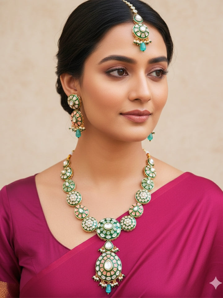 Close-up of a woman wearing an ornate traditional Peach Jewelry Set, Earrings and Mangtikka with Kundan and Colored Stones. Bride wearing a traditional Kundan artificial necklace set for her wedding ceremony. Woman wearing trending Kundan artificial jewelry for wedding season in India.