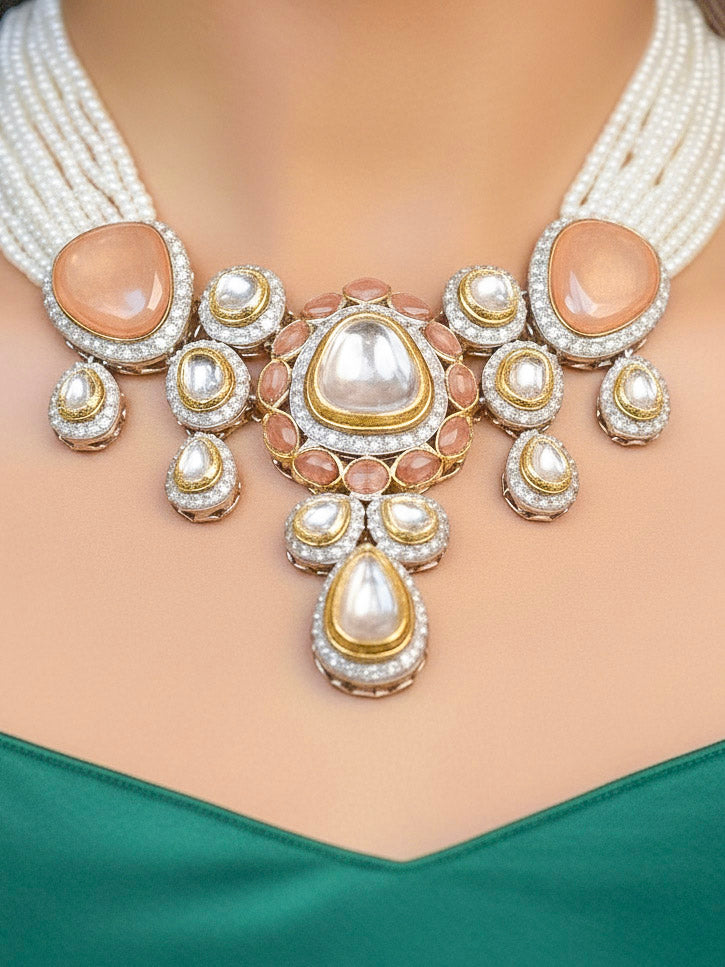 Close-up of a woman wearing an ornate traditional Peach Collar Kundan jewellery set and earrings with American diamonds, Monalisa stone, Pearls, Kundan and Colored Stones. Festive Diwali outfit paired with a premium Kundan jewelry piece. Woman wearing trending Kundan artificial jewelry for wedding season in India.