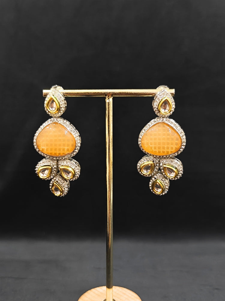 Close-up of an ornate traditional Peach Collar Kundan jewellery set and earrings with American diamonds, Monalisa stone, Pearls, Kundan and Colored Stones. Festive Diwali outfit paired with a premium Kundan jewelry piece. A trending Kundan artificial jewelry for wedding season in India.