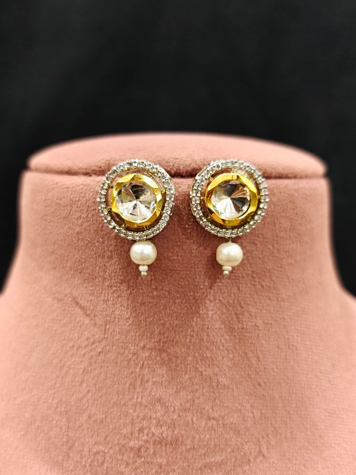 Close-up of an ornate traditional Black Choker jewellery set and earrings with Kundan, American Diamond, Crystal Beads and Pearls. Festive saree styling with a premium artificial Pearls necklace. Mehendi ceremony look completed with a handcrafted Pearls jewelry set.