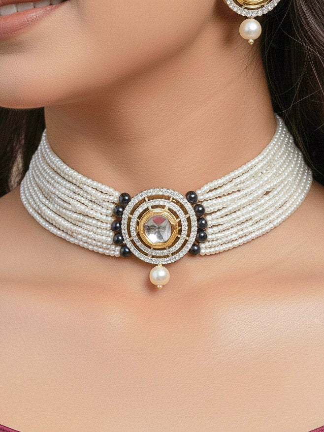 Close-up of a woman wearing an ornate traditional Dark Green Choker jewellery set and earrings with Kundan, American Diamond, Crystal Beads and Pearls. Festive saree styling with a premium artificial Pearls necklace. Mehendi ceremony look completed with a handcrafted Pearls jewelry set.