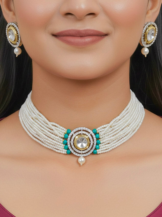 Close-up of a woman wearing an ornate traditional Teel Choker jewellery set and earrings with Kundan, American Diamond, Crystal Beads and Pearls. Festive saree styling with a premium artificial Pearls necklace. Mehendi ceremony look completed with a handcrafted Pearls jewelry set.