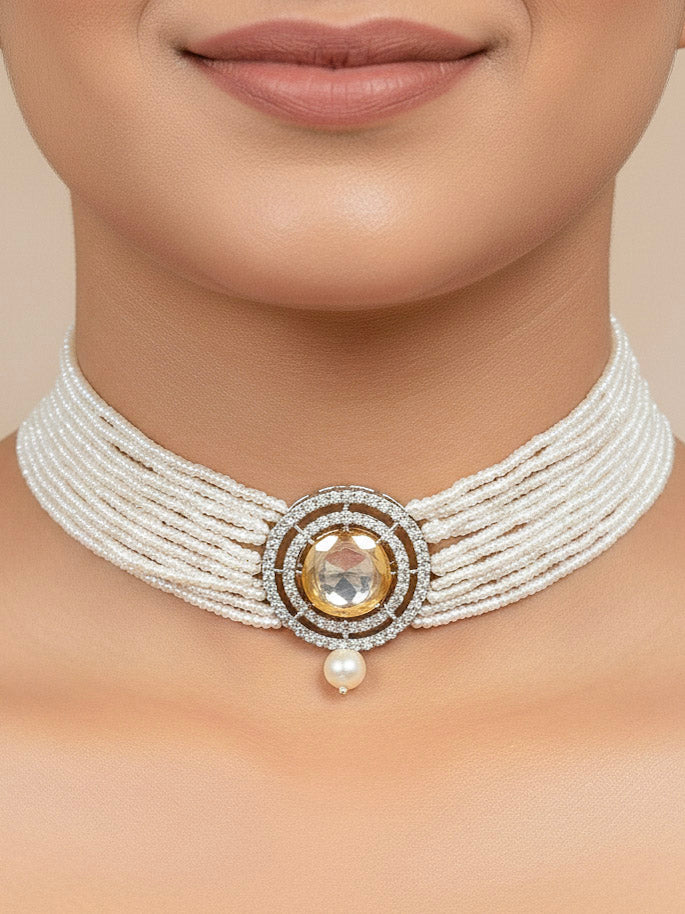 Close-up of a woman wearing an ornate traditional White Choker jewellery set and earrings with Kundan, American Diamond, Crystal Beads and Pearls. Festive saree styling with a premium artificial Pearls necklace. Mehendi ceremony look completed with a handcrafted Pearls jewelry set.