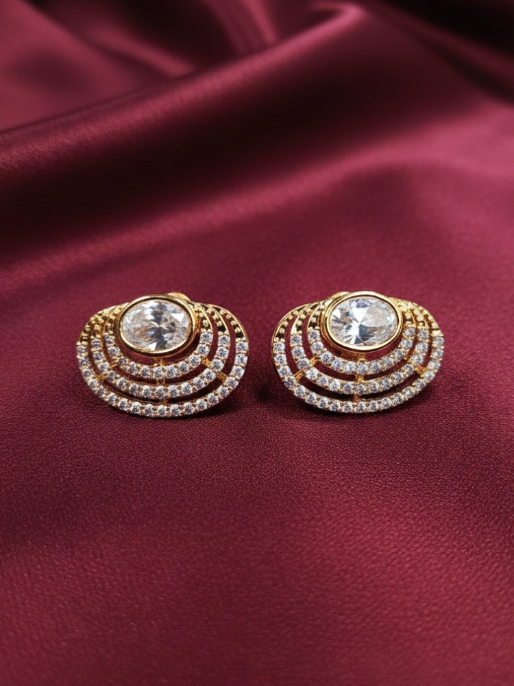 Close-up of a woman wearing an ornate  Western (Gold Polish) White Studs Earrings with American Diamond and Kundan. Indo-western dress styled with lightweight American Diamond artificial Studs Earrings. It’s comfortable and lightweight enough for everyday wear, and it also looks absolutely beautiful and elegant. The design is stylish, the finish is impressive, and it feels really pleasant to wear all day.