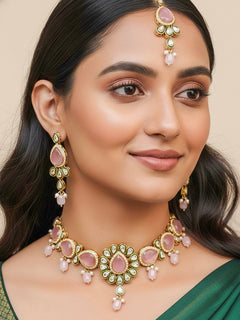 Close-up of a woman wearing an ornate traditional Pink Choker jewellery set and earrings and maangtikka with Kundan, Monalisa Stone, American Diamonds, Beads and Reverse American Diamonds and tumble stones. A graceful woman wearing a trending Colored Stone necklace for a 2026 wedding celebration. Elegant wedding jewelry look featuring a premium artificial Colored Stone necklace.