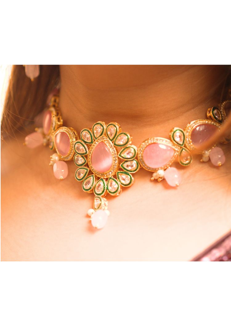 Close-up of a women wearing ornate traditional Pink Choker jewellery set and earrings and maangtikka with Kundan, Monalisa Stone, American Diamonds, Beads and Reverse American Diamonds and tumble stones. A graceful woman wearing a trending Colored Stone necklace for a 2026 wedding celebration. Elegant wedding jewelry look featuring a premium artificial Colored Stone necklace.