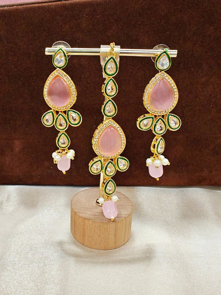 Close-up of a women wearing ornate traditional Pink Choker jewellery set and earrings and maangtikka with Kundan, Monalisa Stone, American Diamonds, Beads and Reverse American Diamonds and tumble stones. A graceful woman wearing a trending Colored Stone necklace for a 2026 wedding celebration. Elegant wedding jewelry look featuring a premium artificial Colored Stone necklace.
