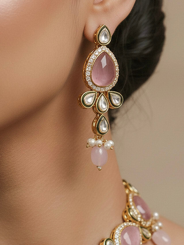 Close-up of a woman wearing an ornate traditional Pink Choker jewellery set and earrings and maangtikka with Kundan, Monalisa Stone, American Diamonds, Beads and Reverse American Diamonds and tumble stones. A graceful woman wearing a trending Colored Stone necklace for a 2026 wedding celebration. Elegant wedding jewelry look featuring a premium artificial Colored Stone necklace.
