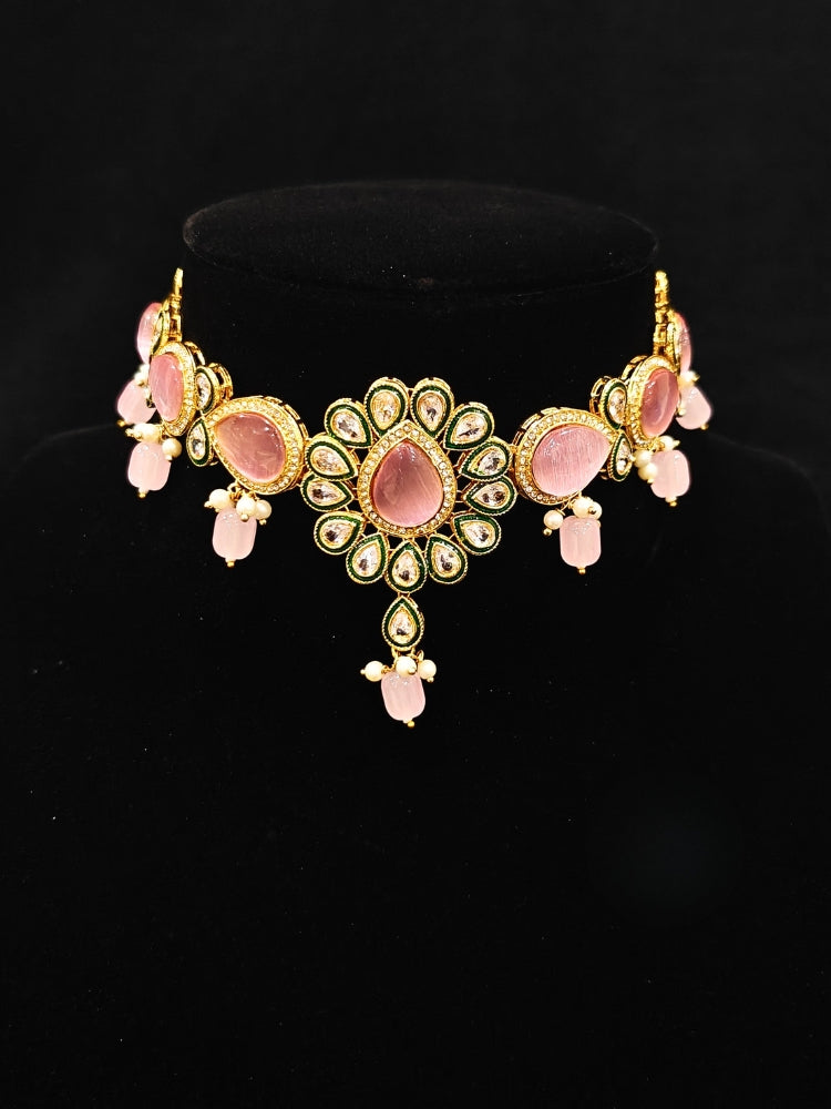 Close-up of an ornate traditional Pink Choker jewellery set and earrings and maangtikka with Kundan, Monalisa Stone, American Diamonds, Beads and Reverse American Diamonds and tumble stones. A graceful woman wearing a trending Colored Stone necklace for a 2026 wedding celebration. Elegant wedding jewelry look featuring a premium artificial Colored Stone necklace.