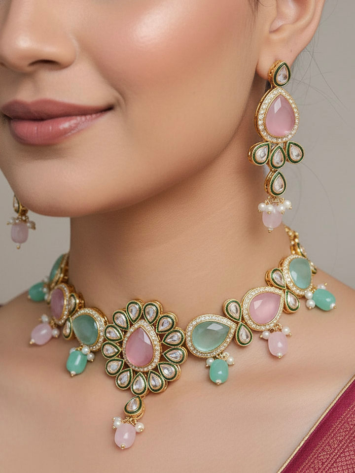 Close-up of a woman wearing an ornate traditional Pink & Green Choker jewellery set and earrings and maangtikka with Kundan, Monalisa Stone, American Diamonds, Beads and Reverse American Diamonds and tumble stones. A graceful woman wearing a trending Colored Stone necklace for a 2026 wedding celebration. Elegant wedding jewelry look featuring a premium artificial Colored Stone necklace.
