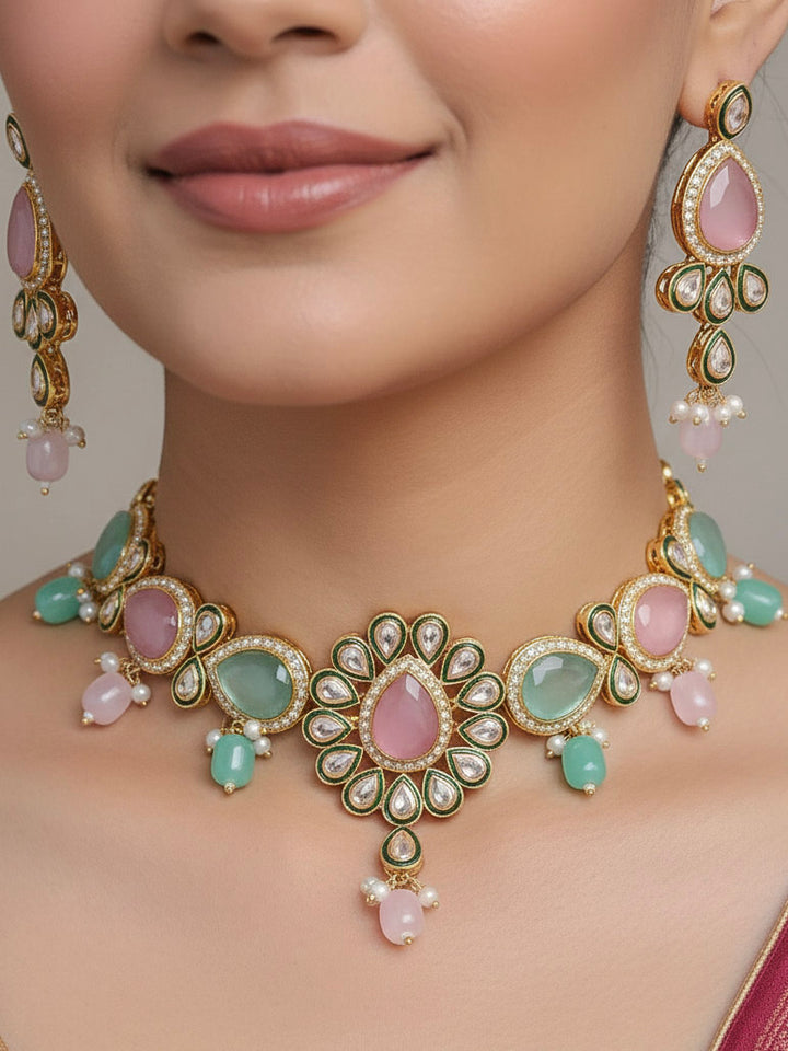 Close-up of a woman wearing an ornate traditional Pink & Green Choker jewellery set and earrings and maangtikka with Kundan, Monalisa Stone, American Diamonds, Beads and Reverse American Diamonds and tumble stones. A graceful woman wearing a trending Colored Stone necklace for a 2026 wedding celebration. Elegant wedding jewelry look featuring a premium artificial Colored Stone necklace.