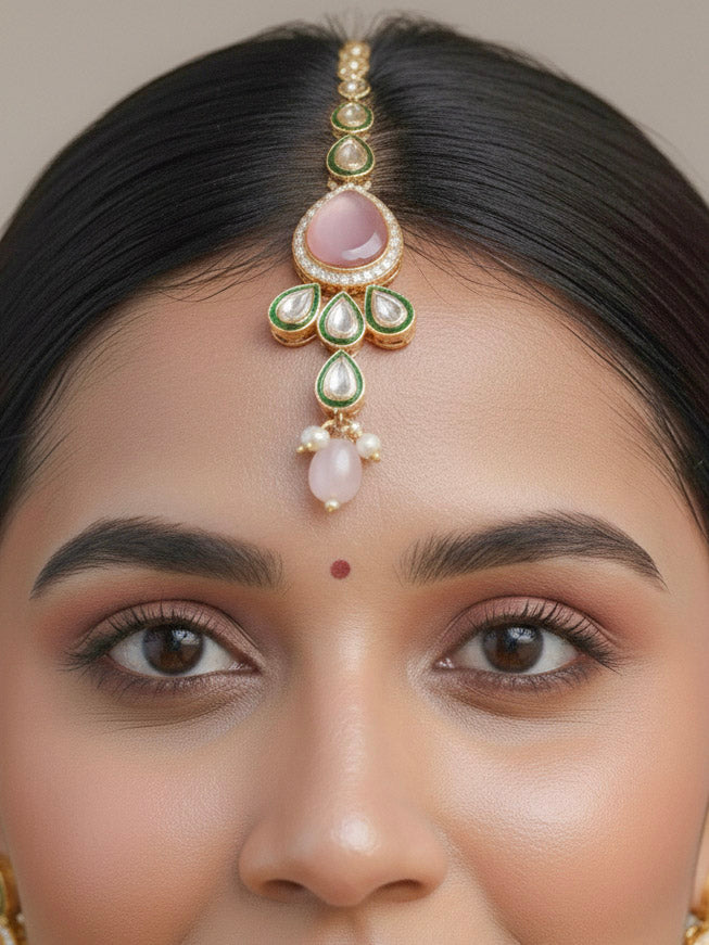Close-up of a woman wearing an ornate traditional Pink & Green Choker jewellery set and earrings and maangtikka with Kundan, Monalisa Stone, American Diamonds, Beads and Reverse American Diamonds and tumble stones. A graceful woman wearing a trending Colored Stone necklace for a 2026 wedding celebration. Elegant wedding jewelry look featuring a premium artificial Colored Stone necklace.