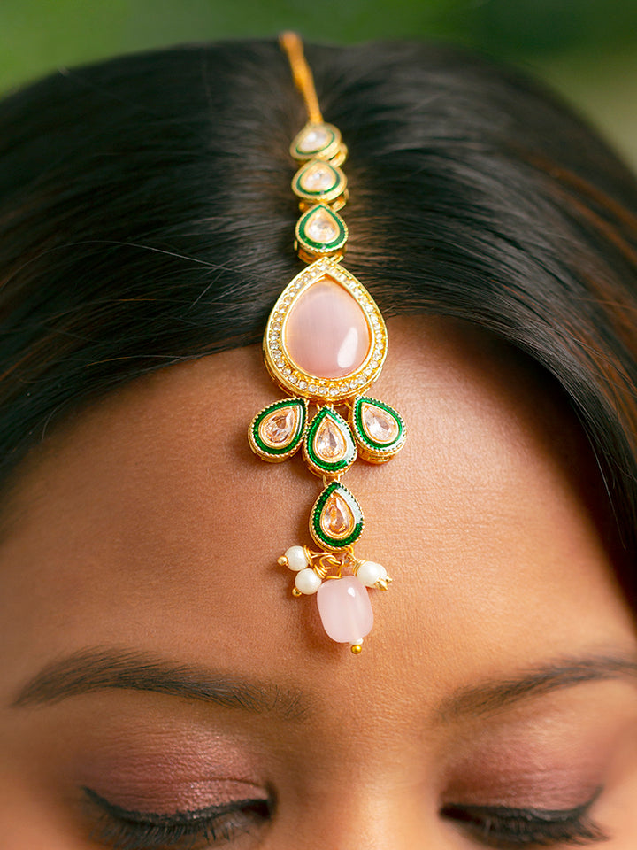 Close-up of a woman wearing an ornate traditional Pink & Green Choker jewellery set and earrings and maangtikka with Kundan, Monalisa Stone, American Diamonds, Beads and Reverse American Diamonds and tumble stones. A graceful woman wearing a trending Colored Stone necklace for a 2026 wedding celebration. Elegant wedding jewelry look featuring a premium artificial Colored Stone necklace.