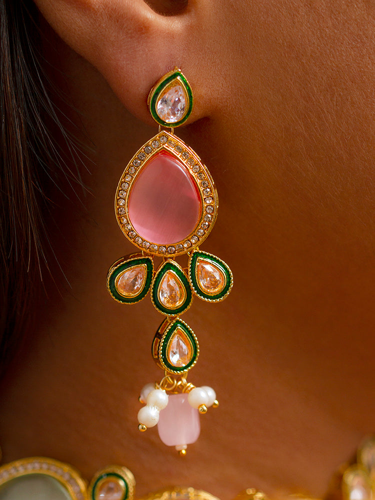 Close-up of a woman wearing an ornate traditional Pink & Green Choker jewellery set and earrings and maangtikka with Kundan, Monalisa Stone, American Diamonds, Beads and Reverse American Diamonds and tumble stones. A graceful woman wearing a trending Colored Stone necklace for a 2026 wedding celebration. Elegant wedding jewelry look featuring a premium artificial Colored Stone necklace.