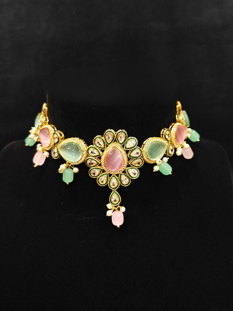 Close-up of an ornate traditional Pink & Green Choker jewellery set and earrings and maangtikka with Kundan, Monalisa Stone, American Diamonds, Beads and Reverse American Diamonds and tumble stones. A graceful woman wearing a trending Colored Stone necklace for a 2026 wedding celebration. Elegant wedding jewelry look featuring a premium artificial Colored Stone necklace.