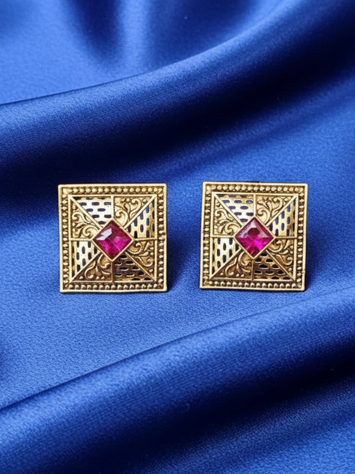 Close-up of a woman wearing an ornate traditional (Gold Polish) Pink Studs Earrings with Pink Colored Stones and Filigree Work. Festive Diwali outfit paired with a premium Kundan Studs Earrings. Perfect for office and Everyday Wear.