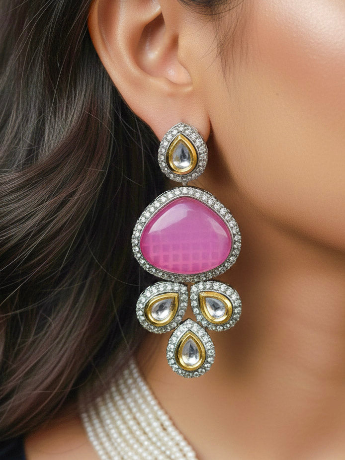 Close-up of a woman wearing an ornate traditional Pink Collar Kundan jewellery set and earrings with American diamonds, Monalisa stone, Pearls, Kundan and Colored Stones. Festive Diwali outfit paired with a premium Kundan jewelry piece. Woman wearing trending Kundan artificial jewelry for wedding season in India.