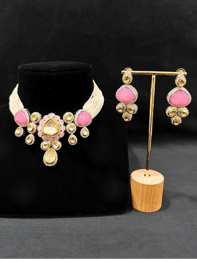 Close-up of an ornate traditional Pink Collar Kundan jewellery set and earrings with American diamonds, Monalisa stone, Pearls, Kundan and Colored Stones. Festive Diwali outfit paired with a premium Kundan jewelry piece. A trending Kundan artificial jewelry for wedding season in India.