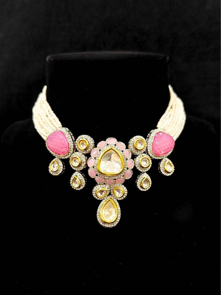 Close-up of an ornate traditional Pink Collar Kundan jewellery set and earrings with American diamonds, Monalisa stone, Pearls, Kundan and Colored Stones. Festive Diwali outfit paired with a premium Kundan jewelry piece. A trending Kundan artificial jewelry for wedding season in India.