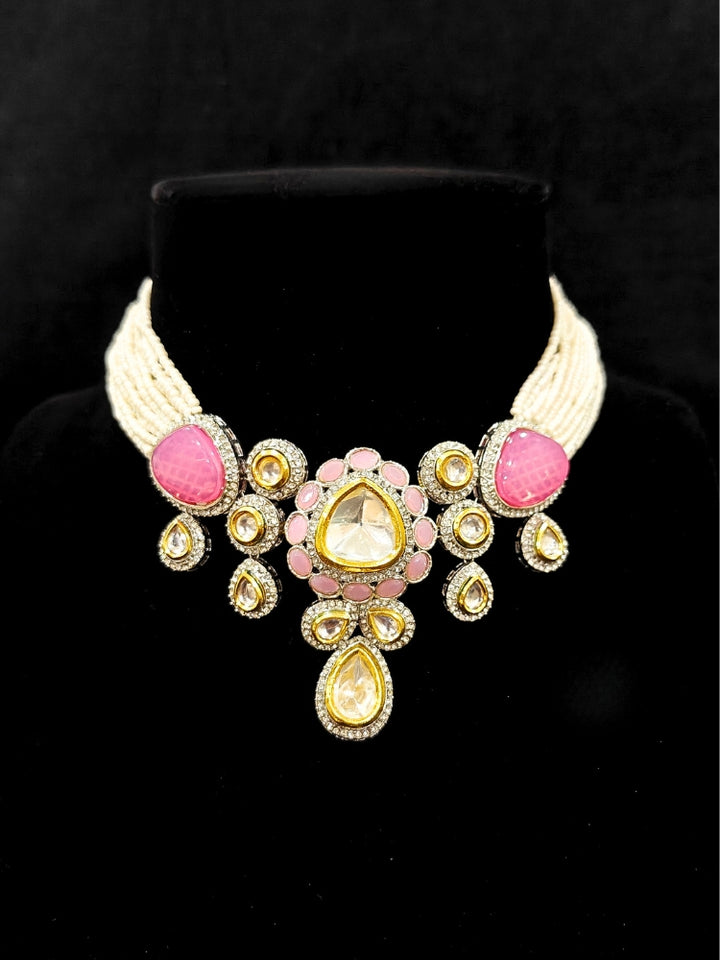 Close-up of an ornate traditional Pink Collar Kundan jewellery set and earrings with American diamonds, Monalisa stone, Pearls, Kundan and Colored Stones. Festive Diwali outfit paired with a premium Kundan jewelry piece. A trending Kundan artificial jewelry for wedding season in India.