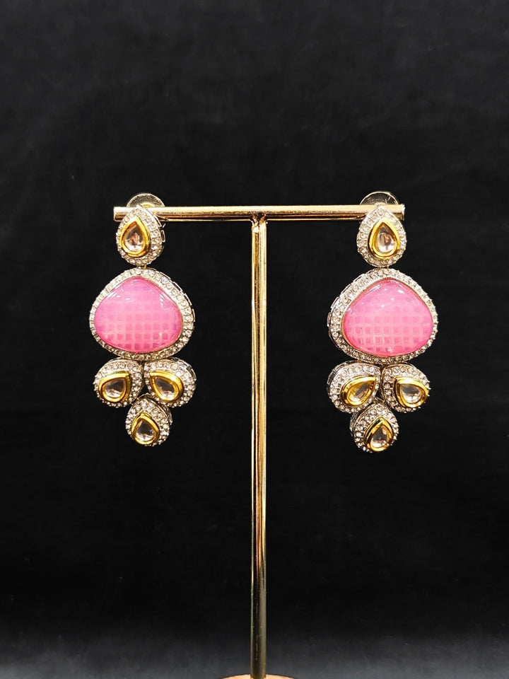 Close-up of an ornate traditional Pink Collar Kundan jewellery set and earrings with American diamonds, Monalisa stone, Pearls, Kundan and Colored Stones. Festive Diwali outfit paired with a premium Kundan jewelry piece. A trending Kundan artificial jewelry for wedding season in India.