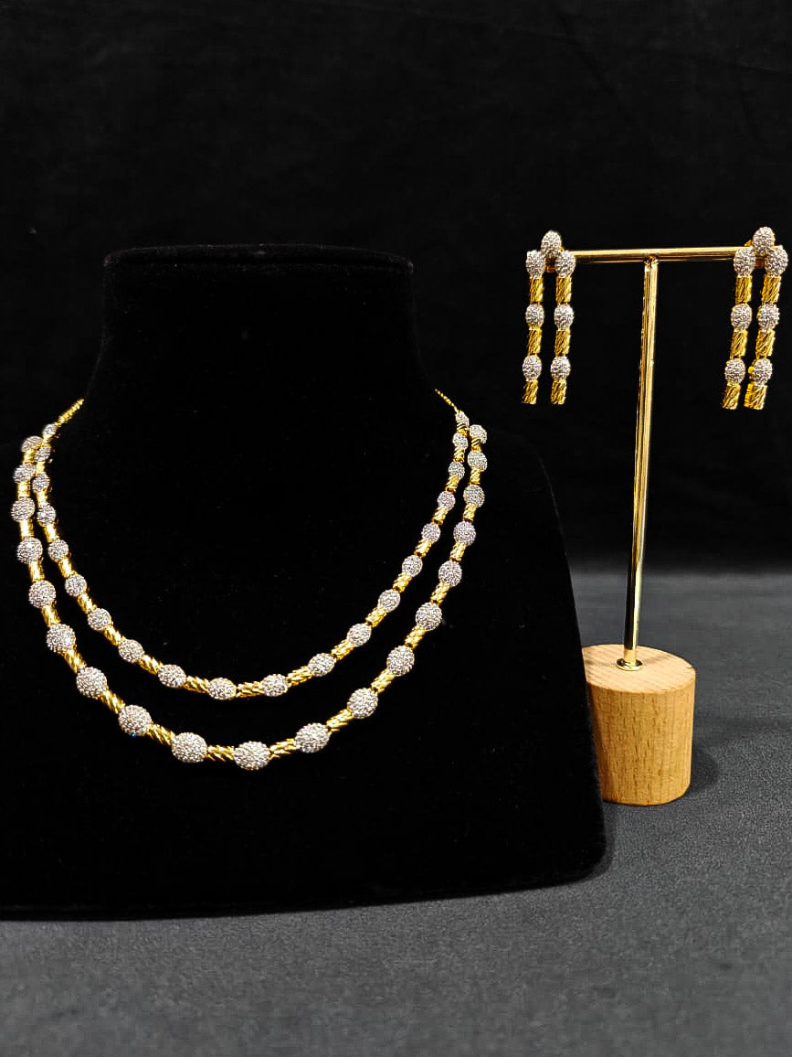 An elegant artificial diamond Layered necklace and matching earrings. This premium artificial diamond jewelry set is perfect for special occasions, from Indian weddings to engagement parties, offering sophisticated glamour without the high price tag.