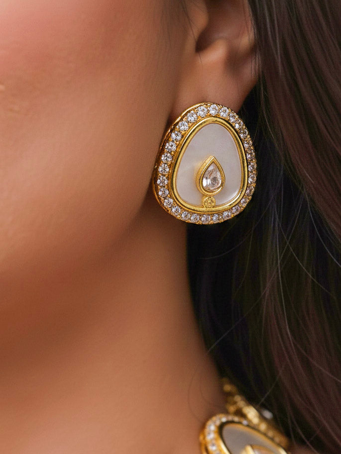 Close-up of a woman wearing an ornate traditional (Gold Polish) White Collar Jewellery Set and Earrings with American Diamond and American Diamonds. Festive celebration look enhanced with sparkling artificial American Diamond jewelry. Saree look completed with elegant artificial American Diamond jewelry for festive occasions.