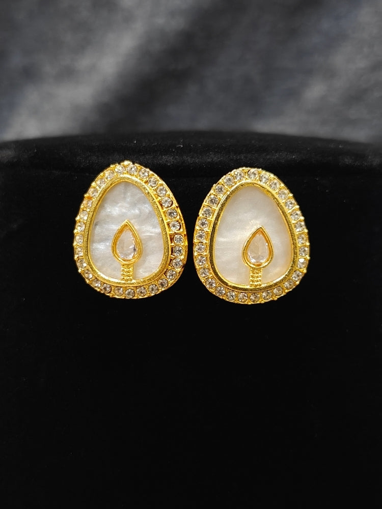 Close-up of an ornate traditional (Gold Polish) White Collar Jewellery Set and Earrings with American Diamond and American Diamonds. Festive celebration look enhanced with sparkling artificial American Diamond jewelry. Saree look completed with elegant artificial American Diamond jewelry for festive occasions.