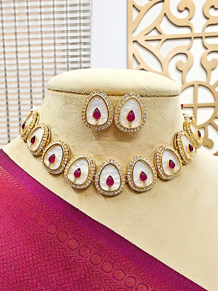 The Pragati Red Necklace Set features white necklace and matching earrings with white oval stones, surrounded by american diamonds, and teardrop-shaped multicolored gems in the center of each oval—perfect Wedding Ceremony Jewelry, shown on a mannequin bust.