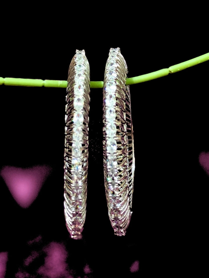Close-up of an ornate Indo-western Silver Bangles with American Diamond. Wedding guest styling elegant artificial American Diamond bangles in India. Close-up of sparkling artificial American Diamond bangles for party wear. Luxury artificial American Diamond bangles styled for a wedding function.
