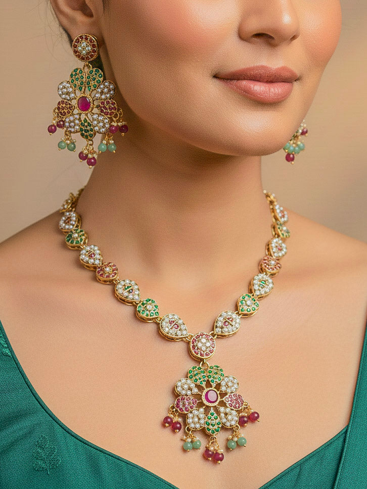 Close-up of a woman wearing an ornate traditional jadau gold jewellery set and jadau earrings with crystal beads and gemstones. Perfect Jadau necklace set for weddings and festivals. 