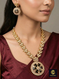 Close-up of a woman wearing an ornate traditional Black Rajwadi gold jewellery set and earrings with Black Colored Stones, Kundan, American Diamond. Festive Diwali outfit enhanced with a Rajwadi artificial necklace. Mehendi ceremony look styled with a Rajwadi artificial jewelry set.