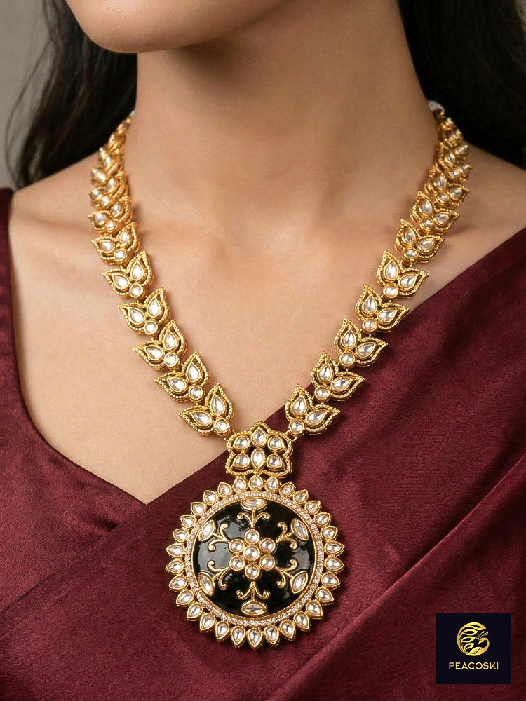 Close-up of a woman wearing an ornate traditional Black Rajwadi gold jewellery set and earrings with Black Colored Stones, Kundan, American Diamond. Festive Diwali outfit enhanced with a Rajwadi artificial necklace. Mehendi ceremony look styled with a Rajwadi artificial jewelry set.