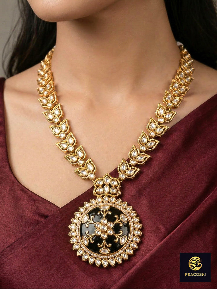 Close-up of a woman wearing an ornate traditional Black Rajwadi gold jewellery set and earrings with Black Colored Stones, Kundan, American Diamond. Festive Diwali outfit enhanced with a Rajwadi artificial necklace. Mehendi ceremony look styled with a Rajwadi artificial jewelry set.