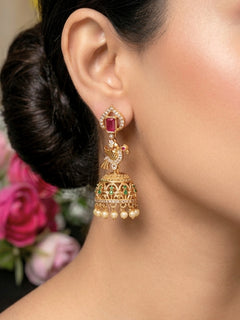 Close-up of a woman wearing an ornate traditional (gold Polish) Diamond Earrings with American Diamond, Colored Stones and Pearls. Wedding guest wearing a sparkling American diamond Earrings with a saree. Festive Diwali outfit styled with an American diamond artificial Earrings.