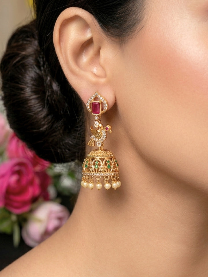 Close-up of a woman wearing an ornate traditional (gold Polish) Diamond Earrings with American Diamond, Colored Stones and Pearls. Wedding guest wearing a sparkling American diamond Earrings with a saree. Festive Diwali outfit styled with an American diamond artificial Earrings.