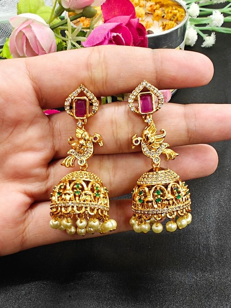 Close-up of a woman wearing an ornate traditional (gold Polish) Diamond Earrings with American Diamond, Colored Stones and Pearls. Wedding guest wearing a sparkling American diamond Earrings with a saree. Festive Diwali outfit styled with an American diamond artificial Earrings.