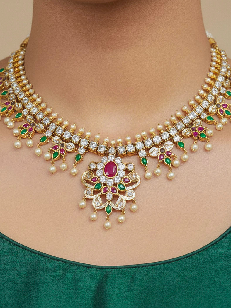 Close-up of a woman wearing an ornate traditional (Gold Polish) Collar jewellery set and earrings with pearls, ruby &amp; Emerald Colored Stone and American Diamond. Festive Diwali outfit styled with an American diamond artificial necklace. Close-up shot of a high-quality American diamond artificial necklace worn for festive celebrations.
