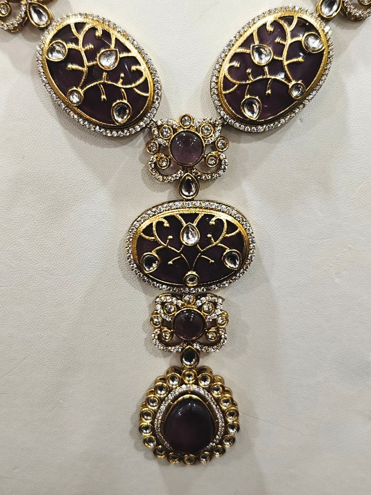 Close-up of an ornate traditional (Mehendi Gold Antique Finish) Purple long Colored Stone jewellery set and earrings with Kundan, Monalisa Stone and American Diamonds. Close-up of a premium imitation Colored Stones jewelry set styled with a aanarkali. A trending Colored Stones artificial jewelry for wedding season in India.