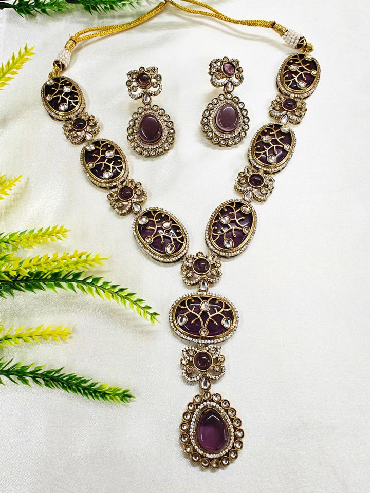 Close-up of a woman wearing a sparkling artificial diamond necklace purple colored stone and diamond earrings set, designed to offer a radiant, elegant look for any formal occasion or Indian wedding. This affordable diamond jewelry provides a flawless, luxurious alternative to natural diamonds.