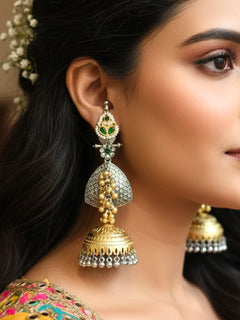 Close-up of a women wearing an ornate traditional (Gold and Silver Polish) Green Long Earrings set with Green Colored Stone. Close-up of anti-tarnish artificial Oxidized earrings for festive celebrations. Festive saree look completed with premium imitation Oxidized earrings.
