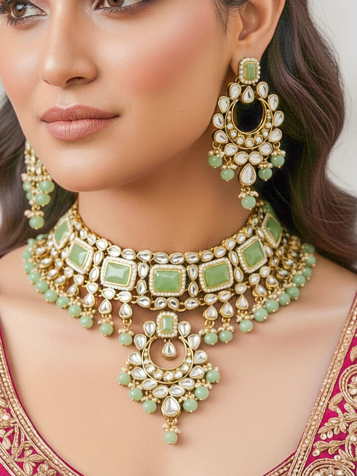 Close-up of a woman wearing an ornate traditional Green Kundan Choker jewellery set and earrings and maangtikka with Kundan, Mint green Stone, Pearls and Mint Green Crystal Beads. Bride wearing a royal Kundan artificial necklace for wedding rituals. Wedding celebration look enhanced with a statement Kundan necklace. 