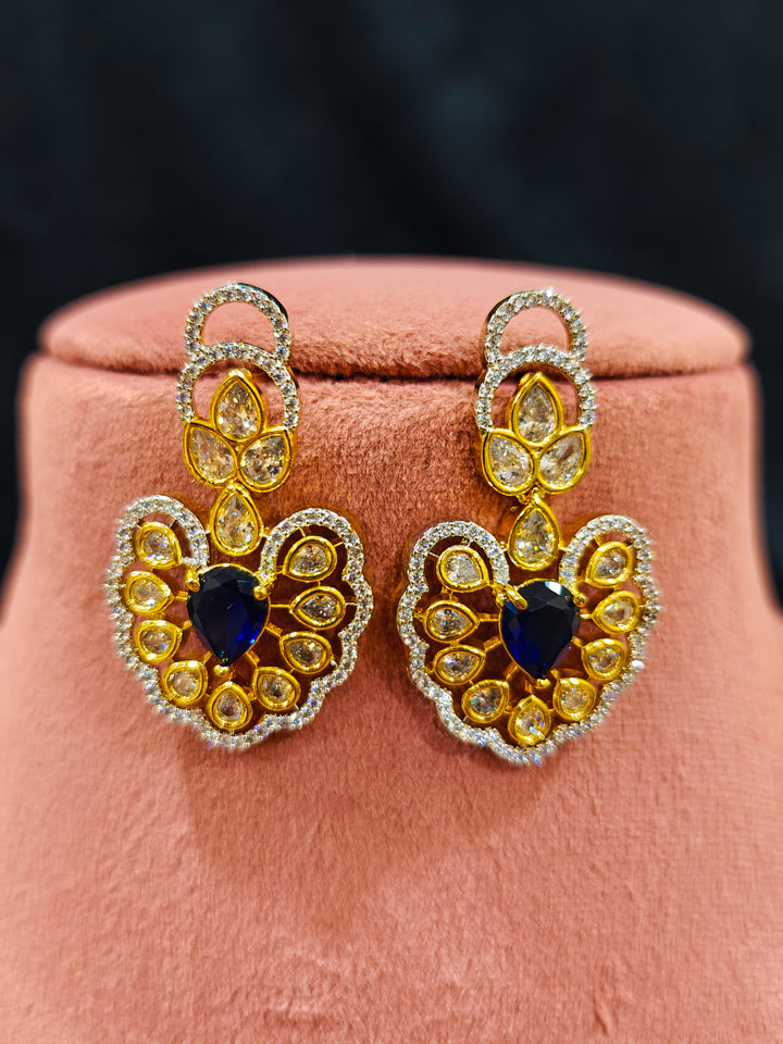 Close-up of an ornate Western American diamond Raizel Blue Necklace Set (Dual Tone) Collar jewellery set and earrings with Colored Stone and American Diamond. Close-up of a cocktail party look featuring a premium American diamond necklace.
