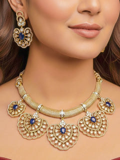 Close-up of a woman wearing an ornate Western American diamond Raizel Blue Necklace Set (Mehendi Polish) Collar jewellery set and earrings with Colored Stone and American Diamond. Reception-ready look featuring a statement American diamond jewelry set.