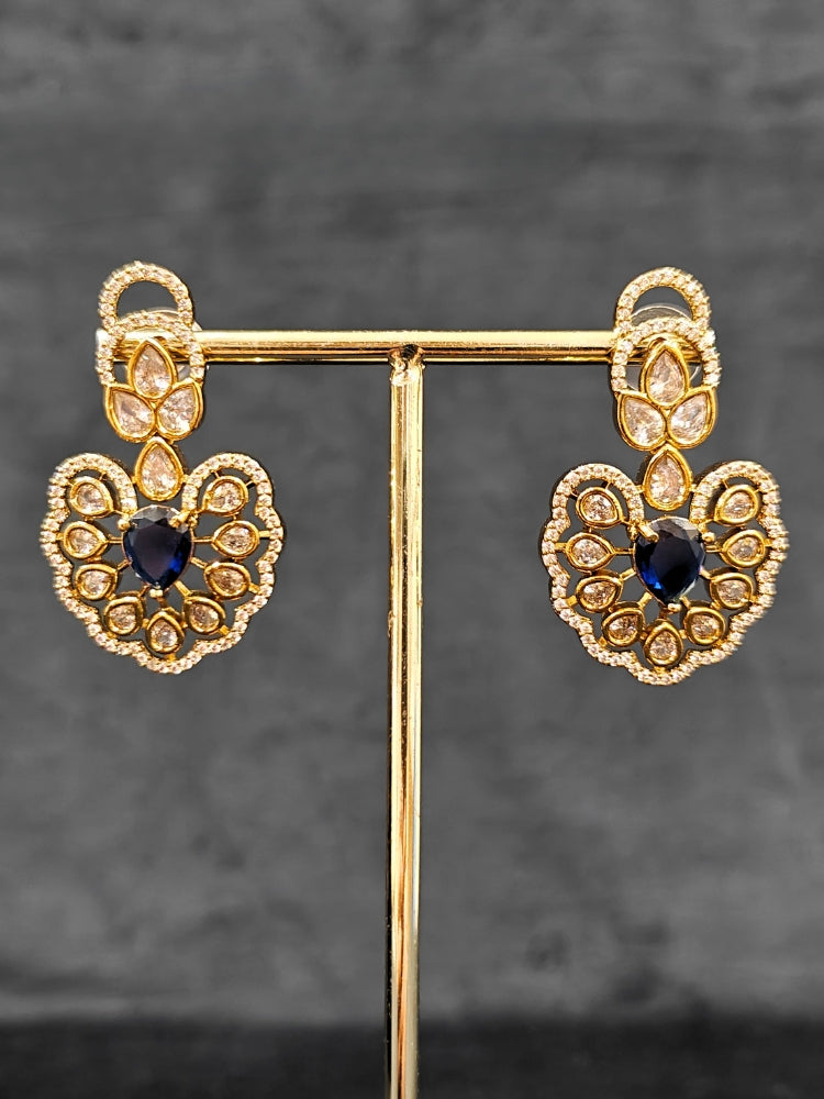 Close-up of an ornate Western American diamond Raizel Blue Necklace Set (Mehendi Polish) Collar jewellery set and earrings with Colored Stone and American Diamond. Reception-ready look featuring a statement American diamond jewelry set.