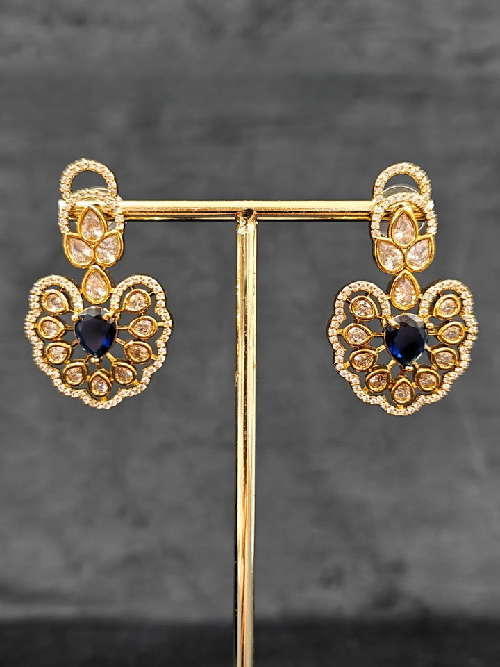 Close-up of an ornate Western American diamond Raizel Blue Necklace Set (Mehendi Polish) Collar jewellery set and earrings with Colored Stone and American Diamond. Reception-ready look featuring a statement American diamond jewelry set.