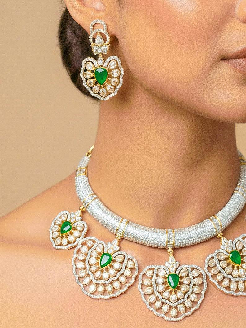 Close-up of a woman wearing an ornate Western American diamond Raizel Emerald Green Necklace Set (Dual Tone) Collar jewellery set and earrings with  Colored Stone and American Diamond. Bride-to-be styled in a premium American diamond artificial necklace for her reception party.